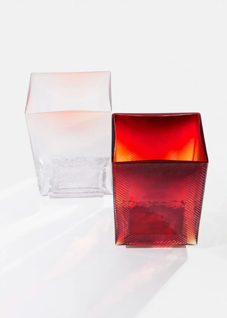 Red and clear textured glass vases on white background.