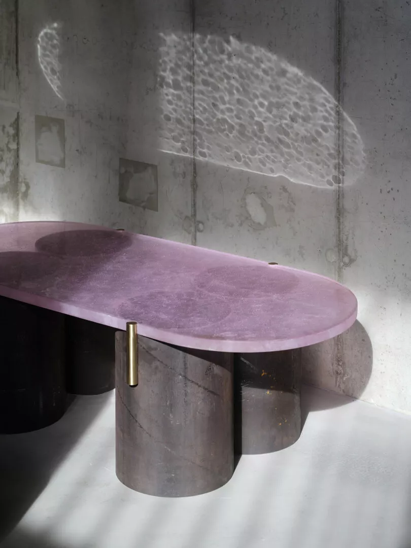 Modern purple marble table casting shadows in sunlight.