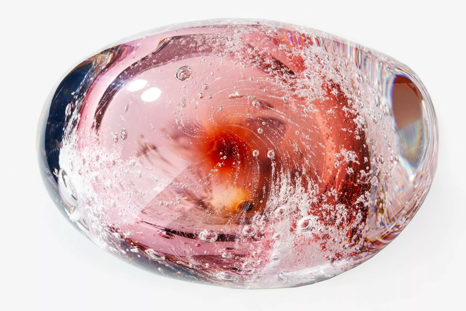 Colorful glass paperweight with bubbles and swirls.