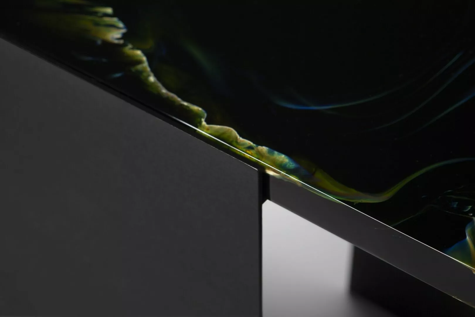 Close-up of glossy, greenish abstract design on monitor.