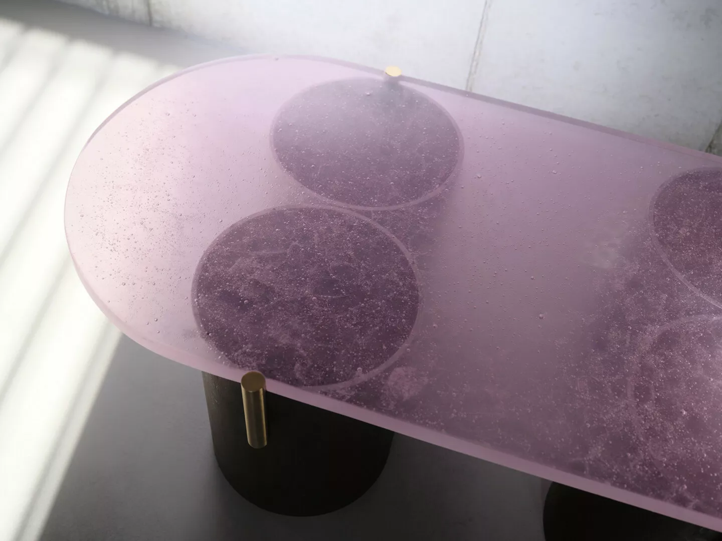 Purple resin table with embedded circular designs.