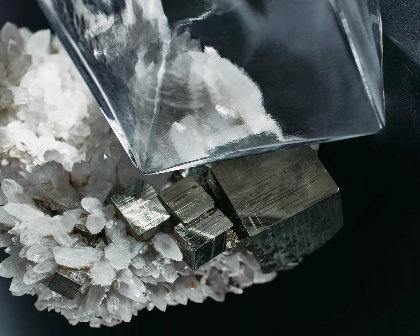 Pyrite crystals and poured white powder on dark background.