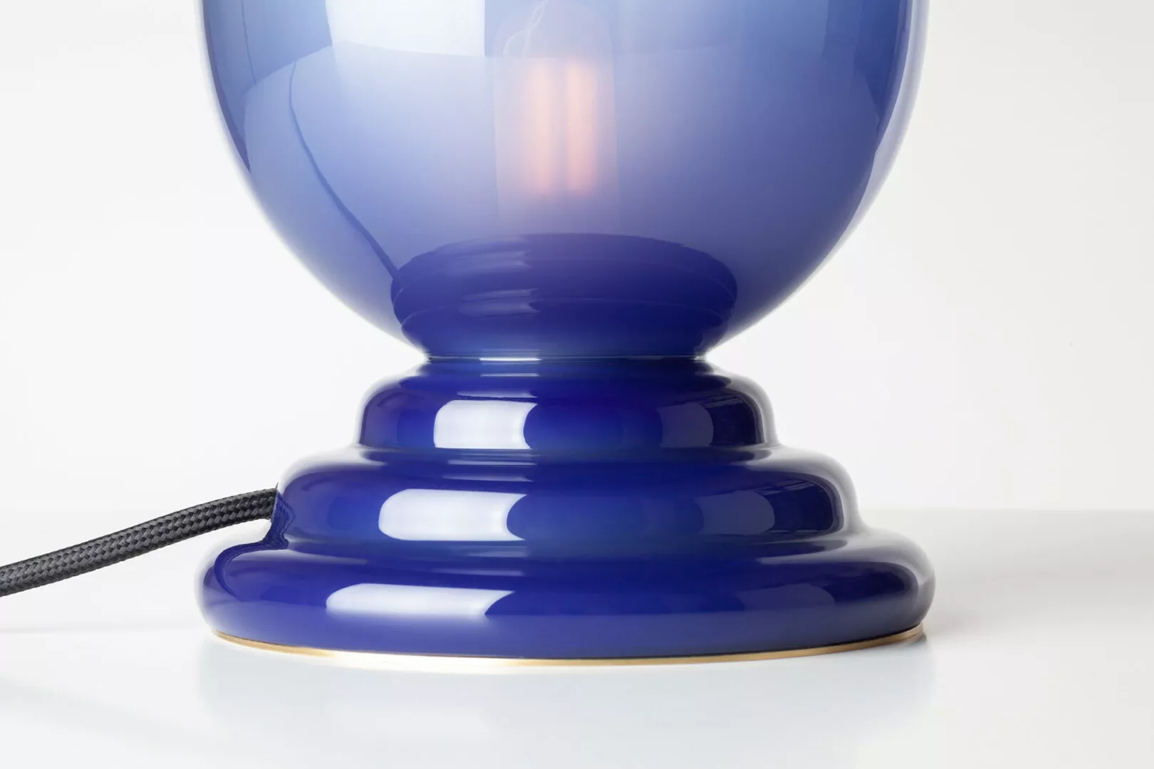 Close-up of blue ceramic lamp base.