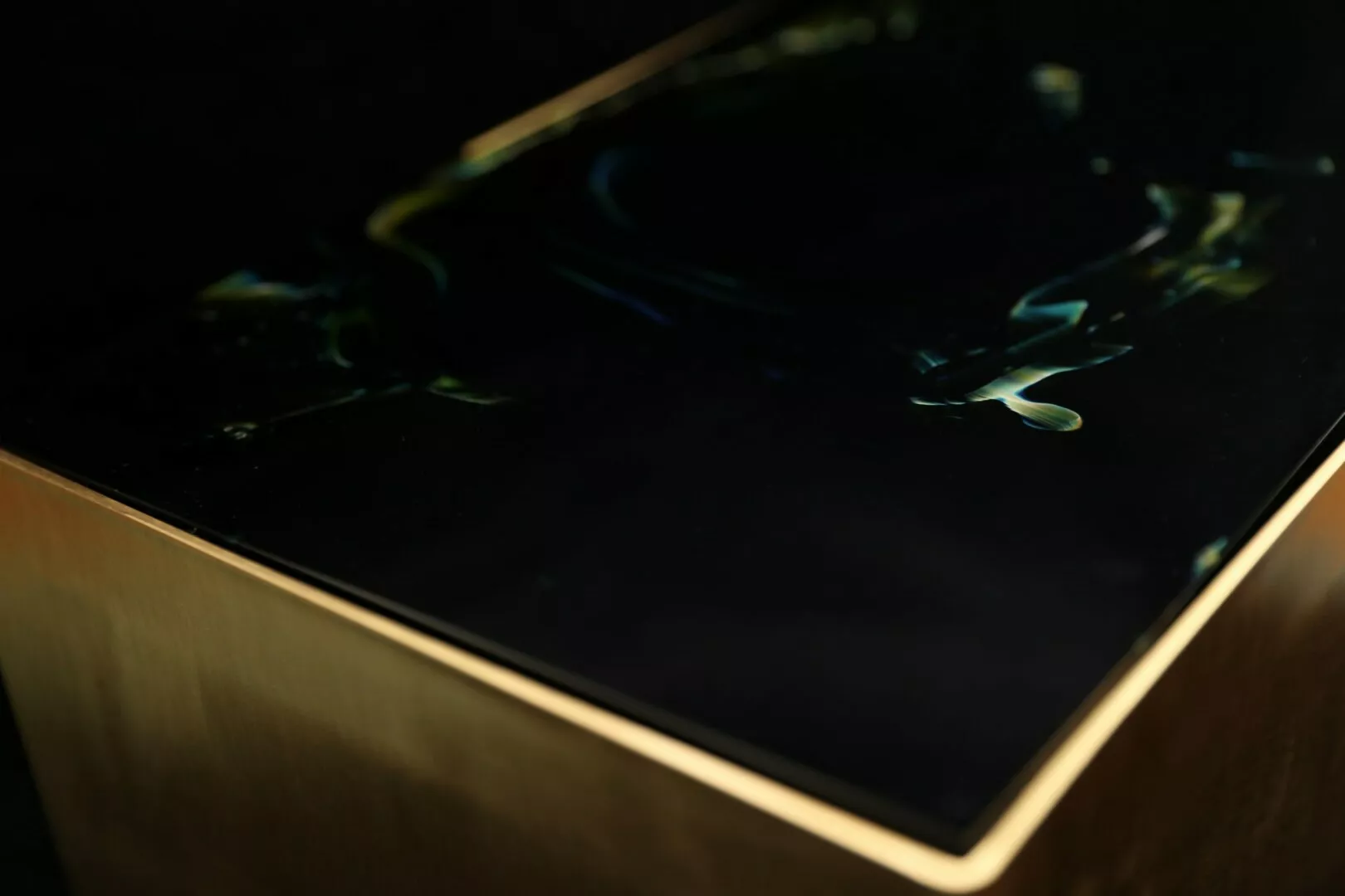 Abstract dark surface with reflections.