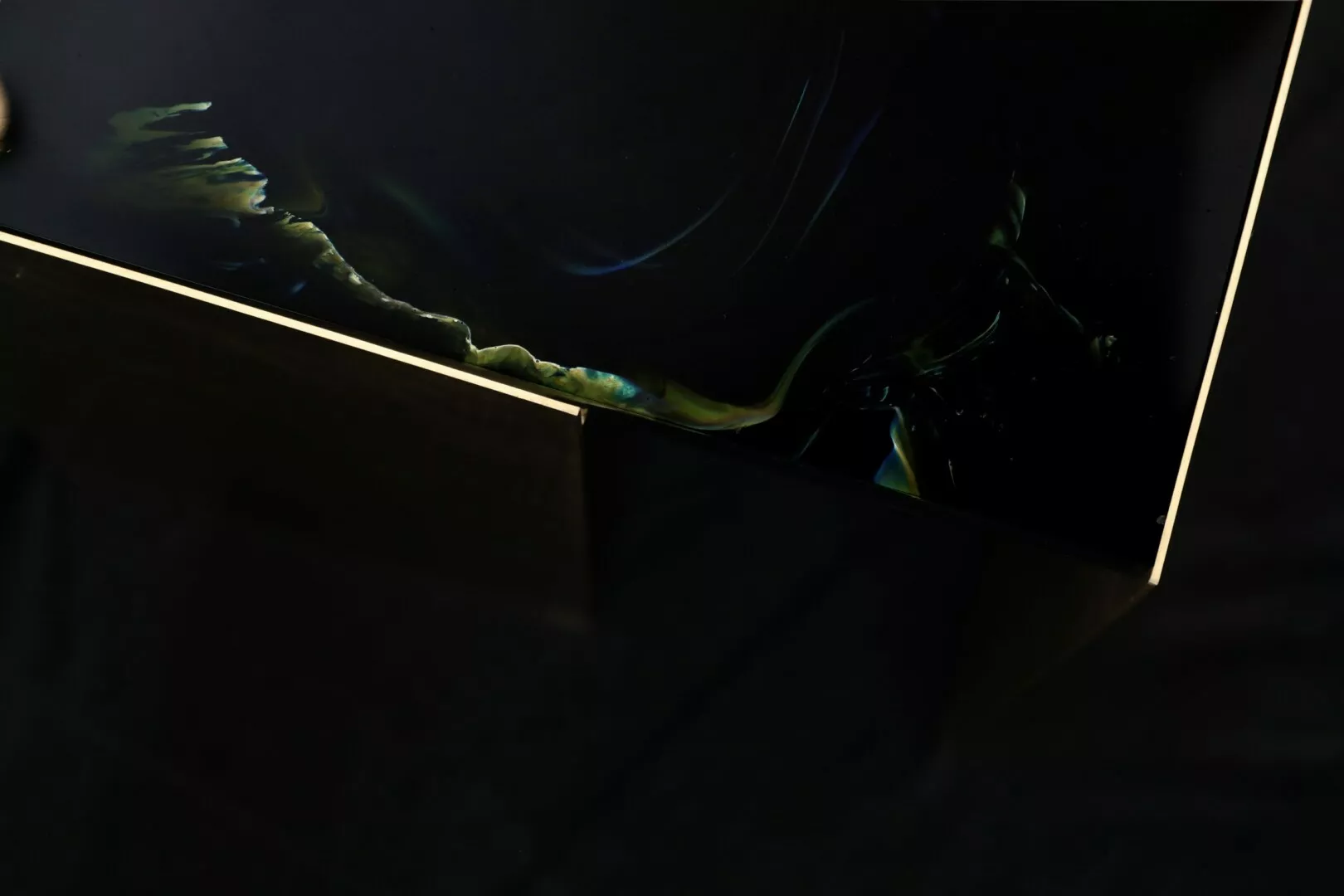 Abstract dark reflections on glossy surface.