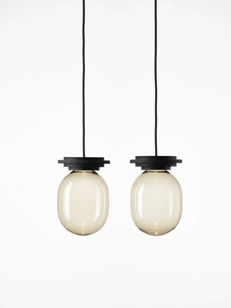 Two modern hanging pendant lights with clear glass shades.