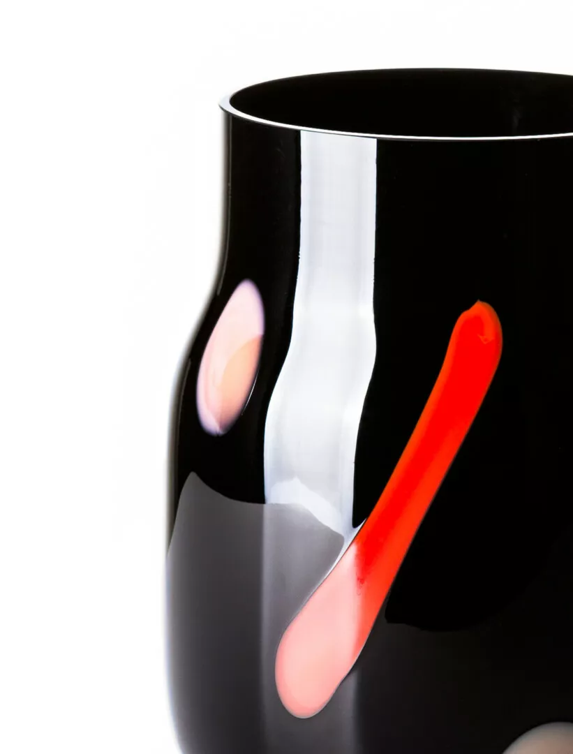 Black ceramic vase with colorful abstract accents.