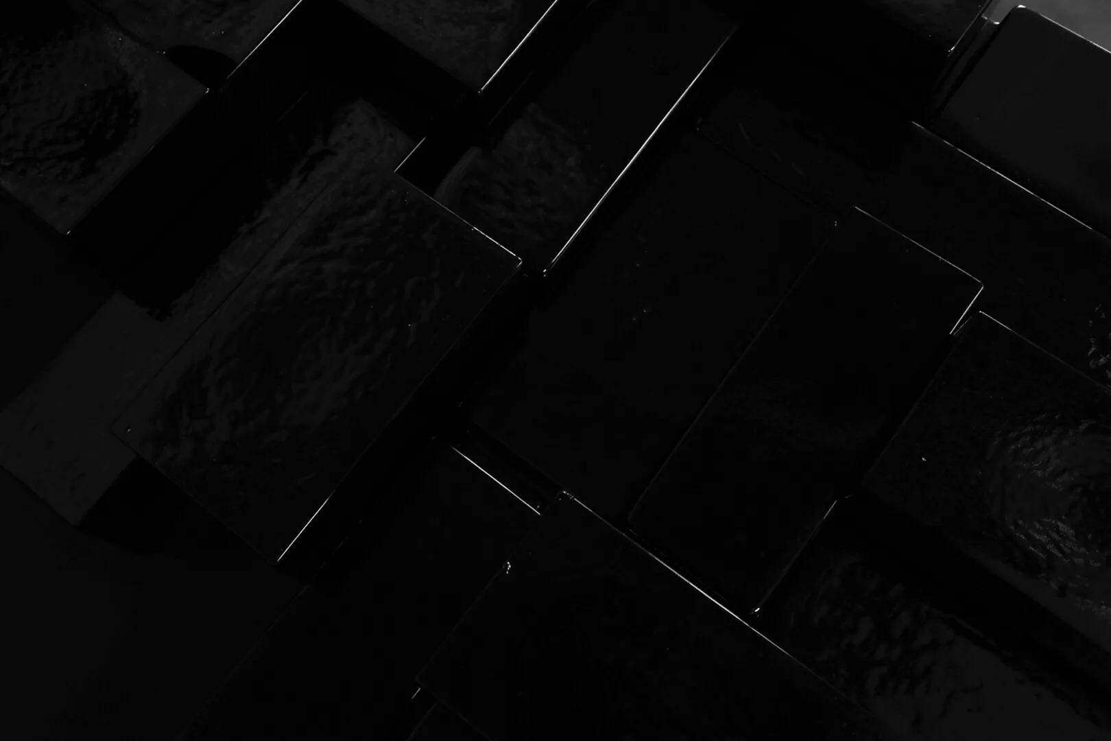 Abstract black water patterns on textured surface.