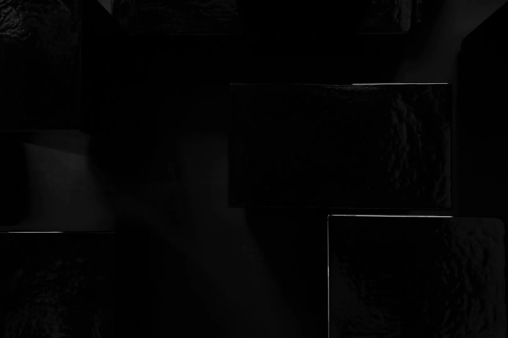 Abstract black geometric shapes, textured surfaces.