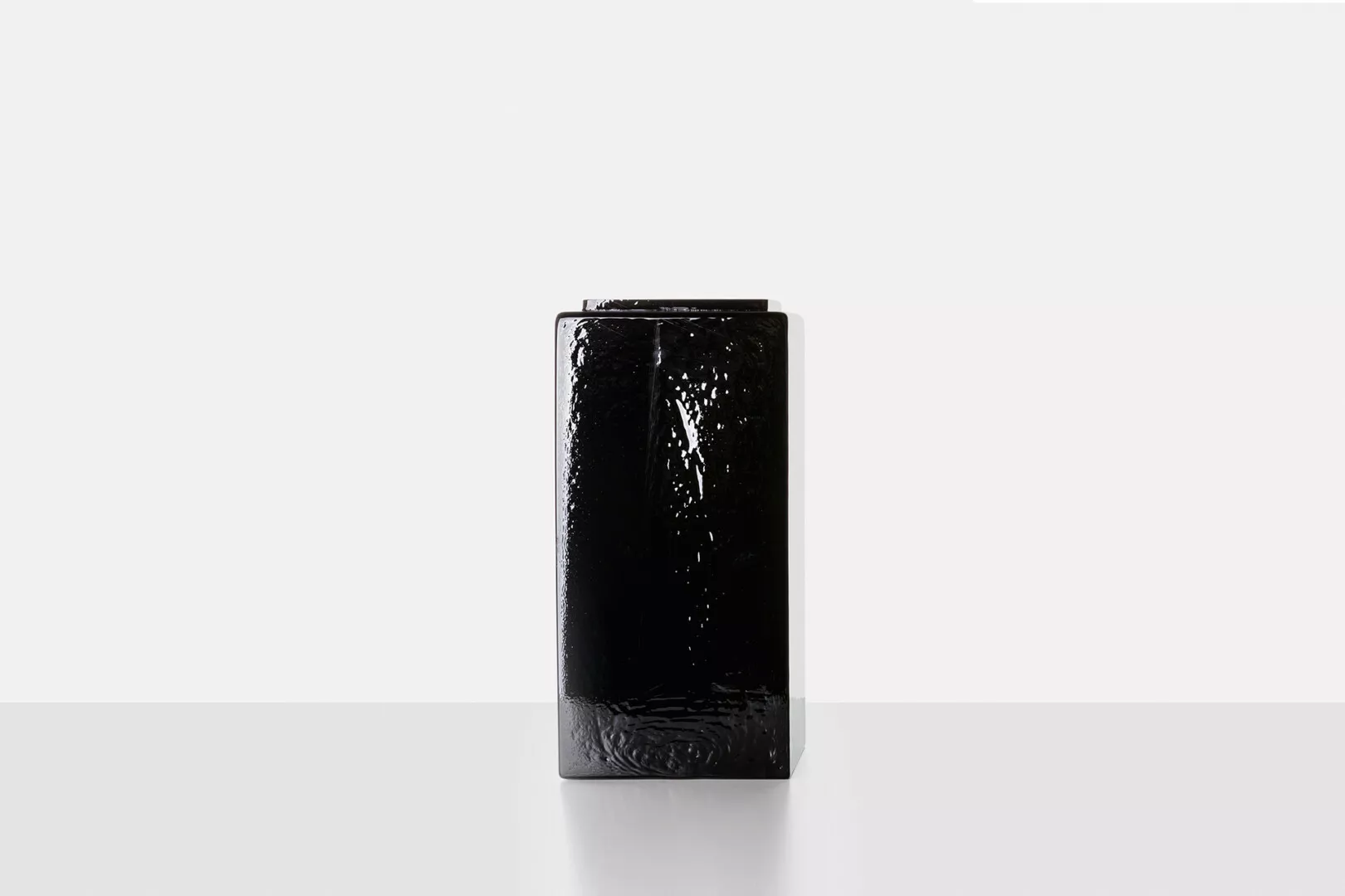 Black textured vase on white background.