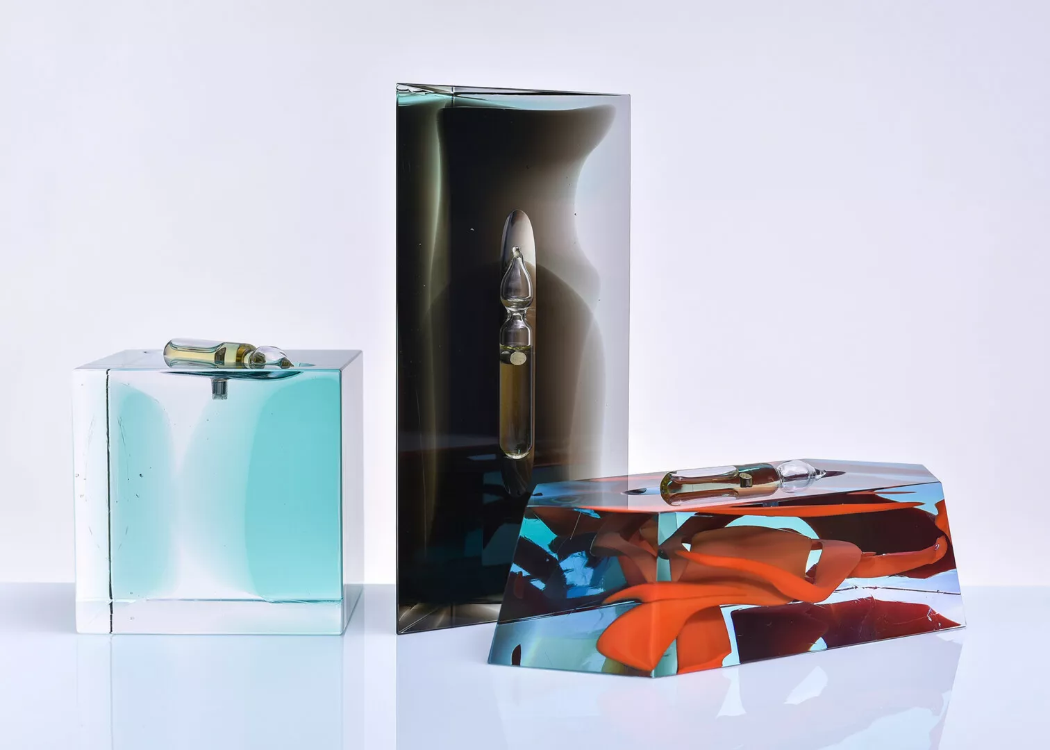 Artistic resin blocks with suspended glass ampoules.