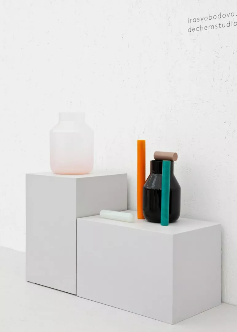 Minimalist decor with colorful vases on white blocks
