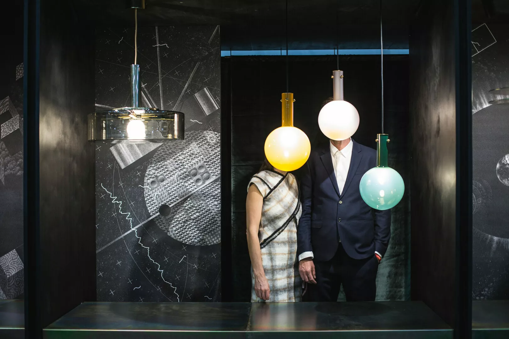 Art installation with people, globe lamps as heads.
