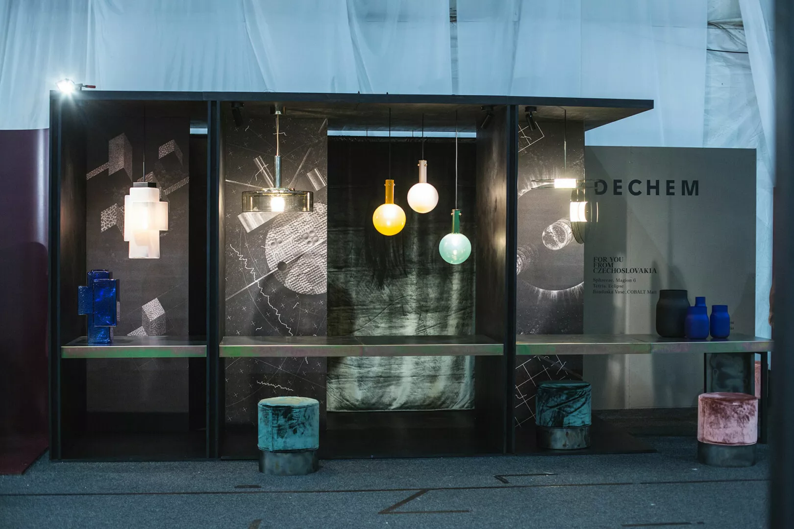 Modern glass lighting display at Dechem exhibition booth.
