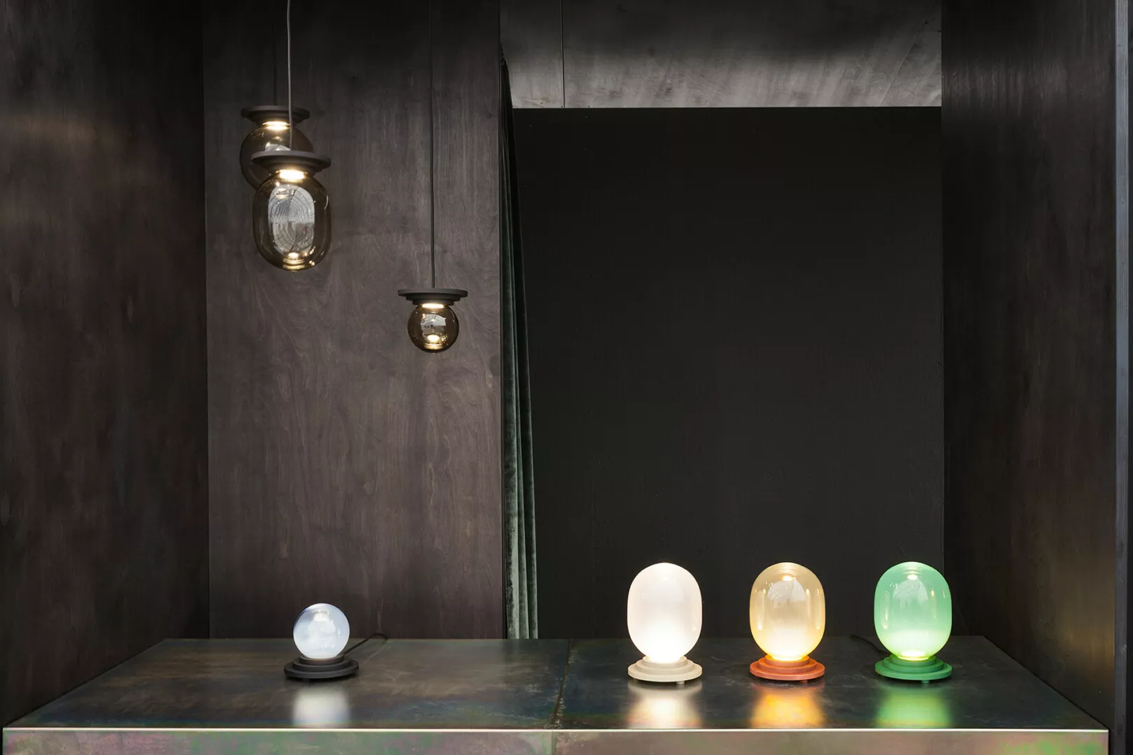 Modern lamps display on dark textured background.