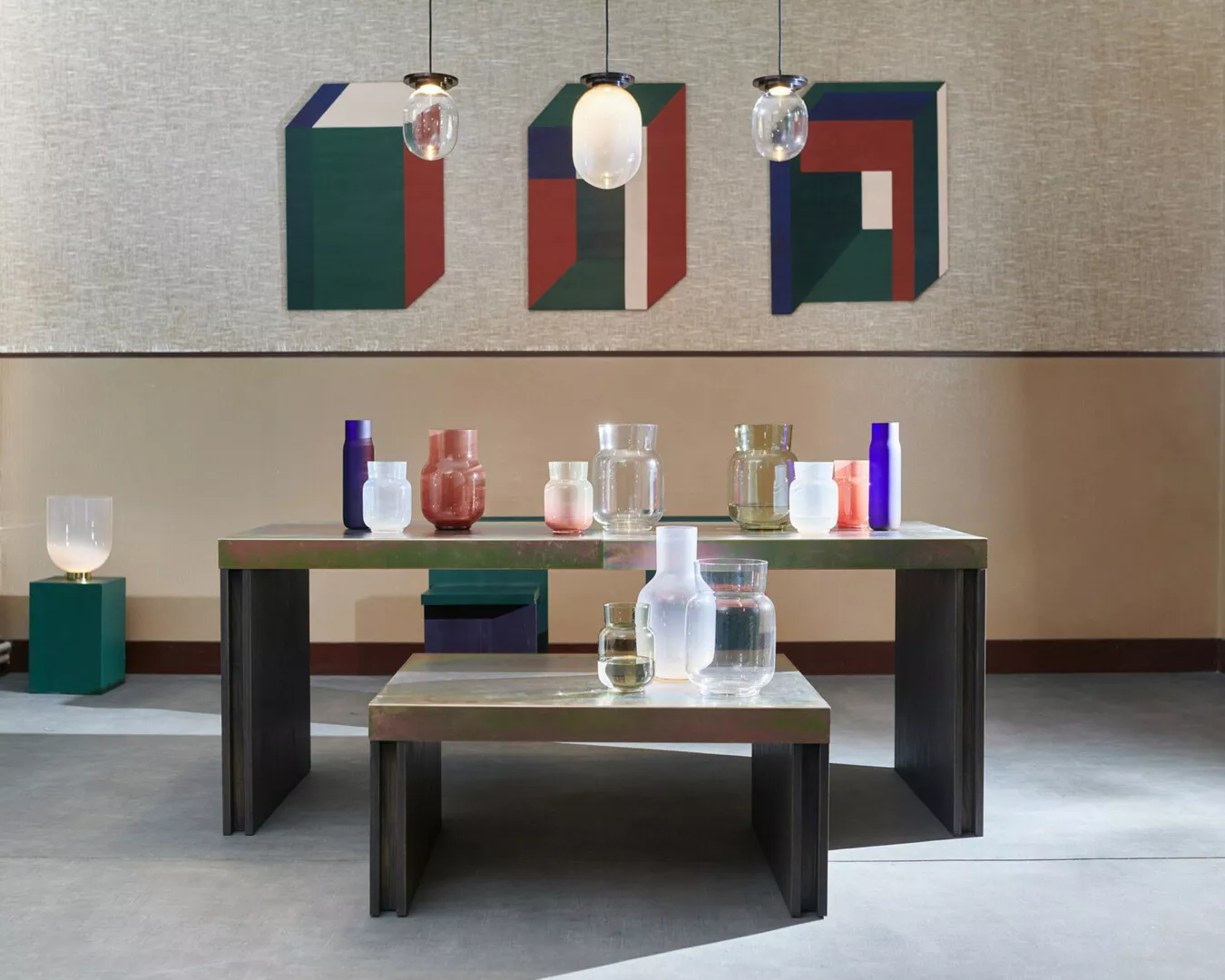 Modern minimalist interior with colorful glassware on table