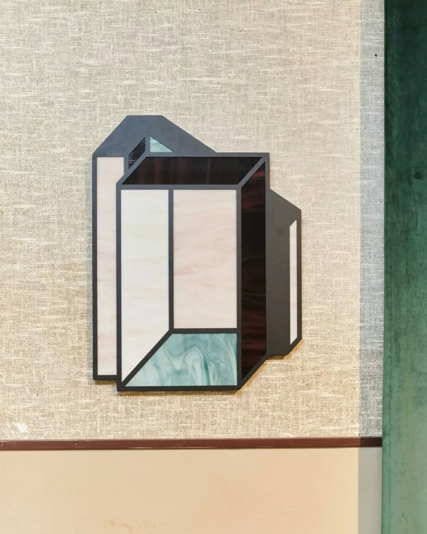 Abstract geometric wall art in muted tones.