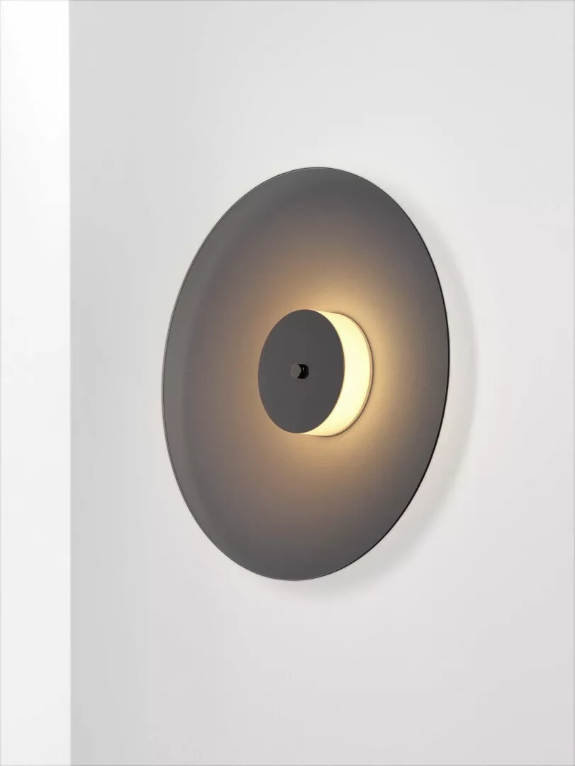 Modern wall-mounted circular LED light fixture.