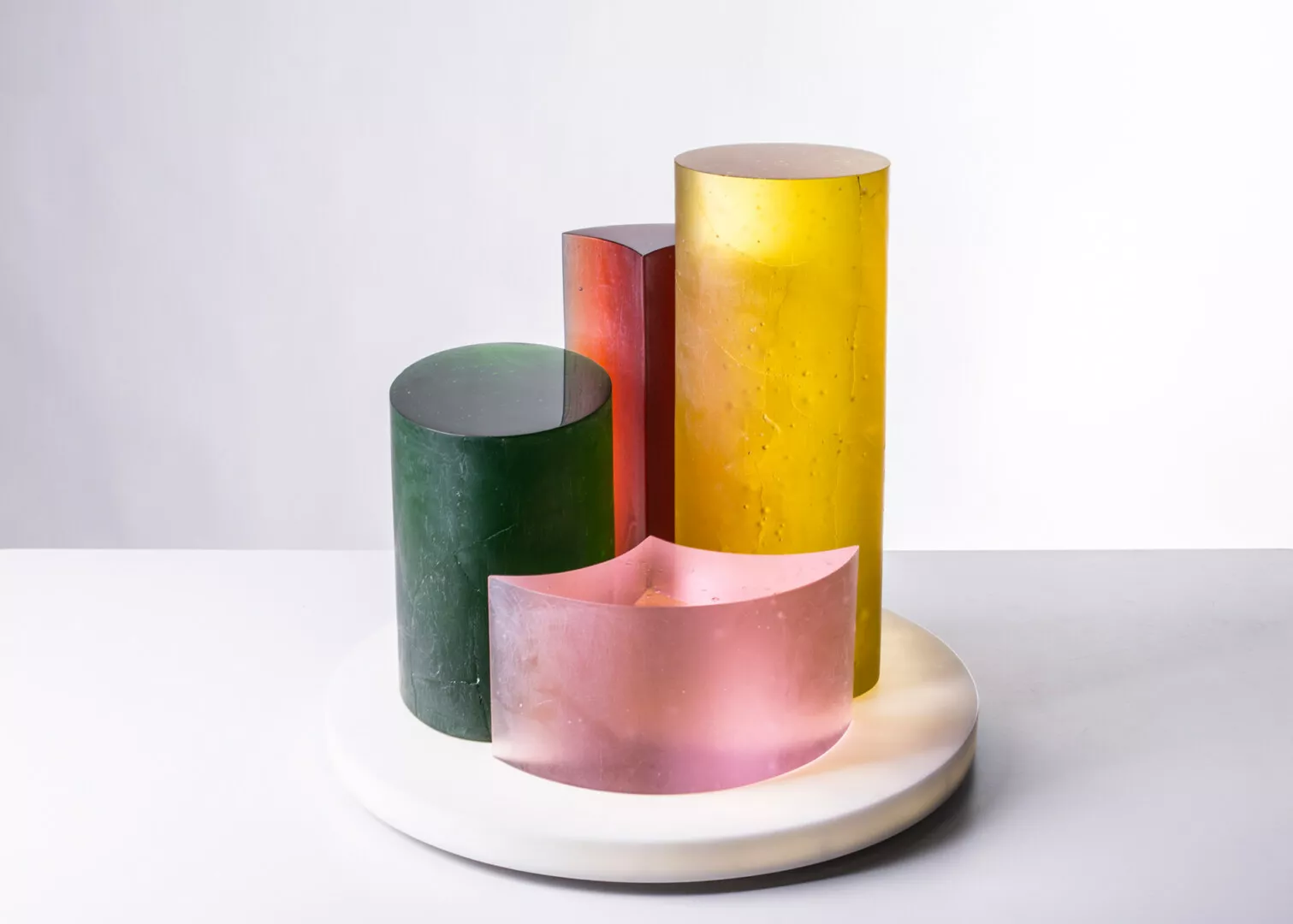 Colorful resin cylinders on white surface