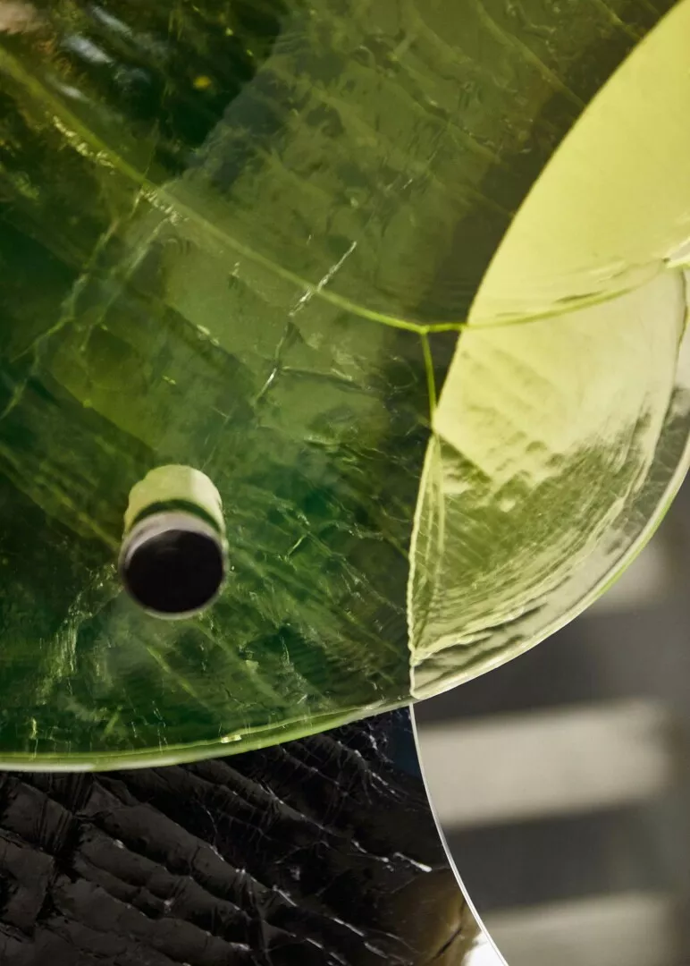 Close-up of cracked green and yellow glass texture.