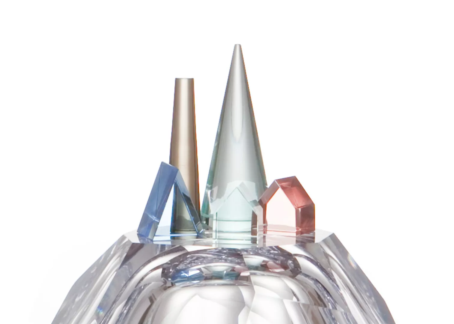 Colorful geometric glass sculptures on reflective surface.