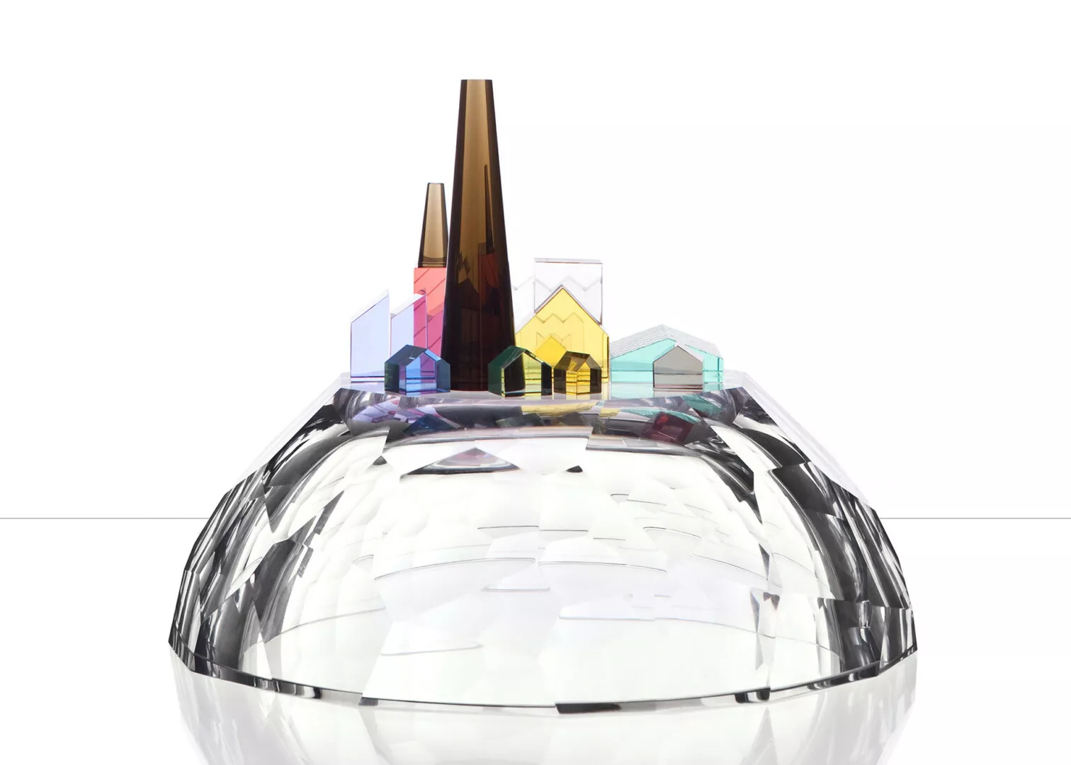 Colorful glass cityscape on reflective surface.