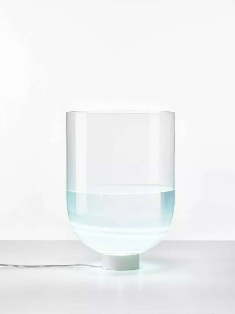 Clear glass humidifier with water on white background.