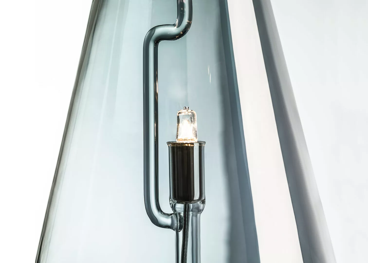Close-up of illuminated halogen bulb in glass tube.