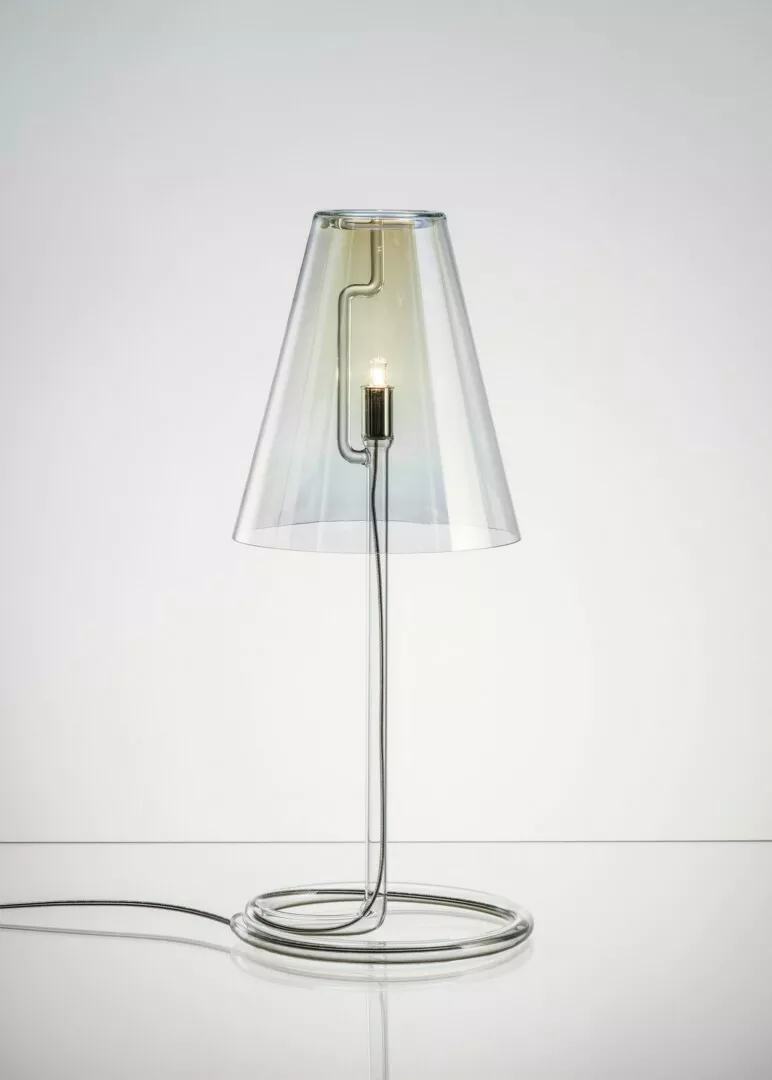 Transparent modern lamp with visible filament on white.
