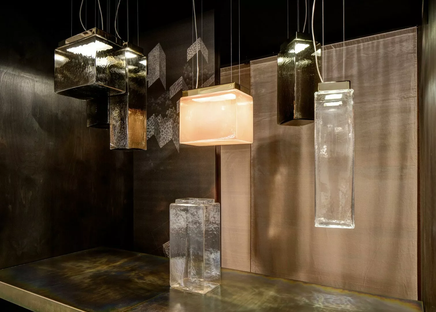 Modern designer pendant lamps in dark interior setting.