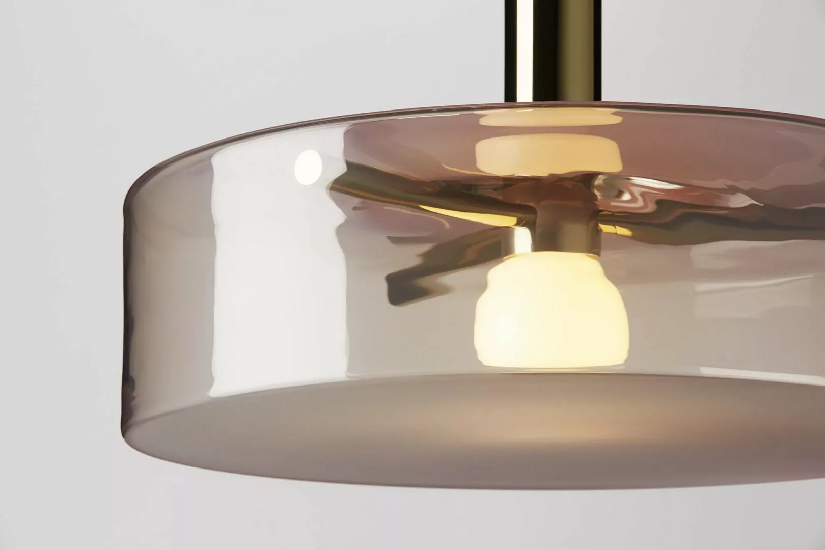 Close-up of modern pendant light with reflective surface.