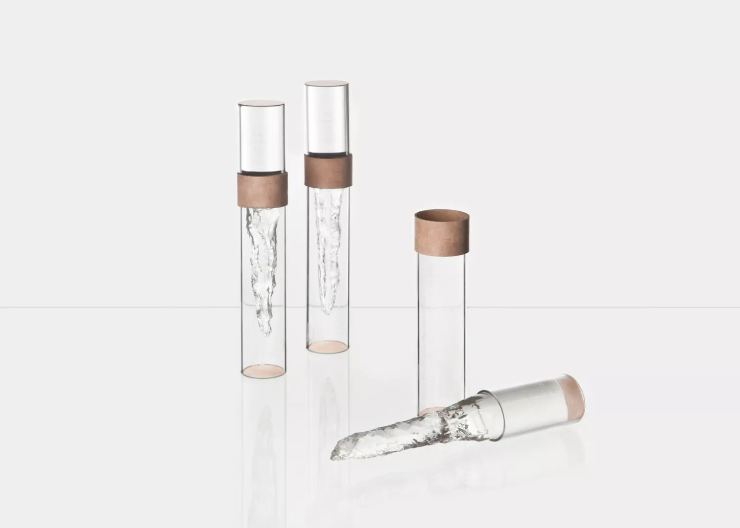 Marble-patterned lipstick in clear cylindrical containers.