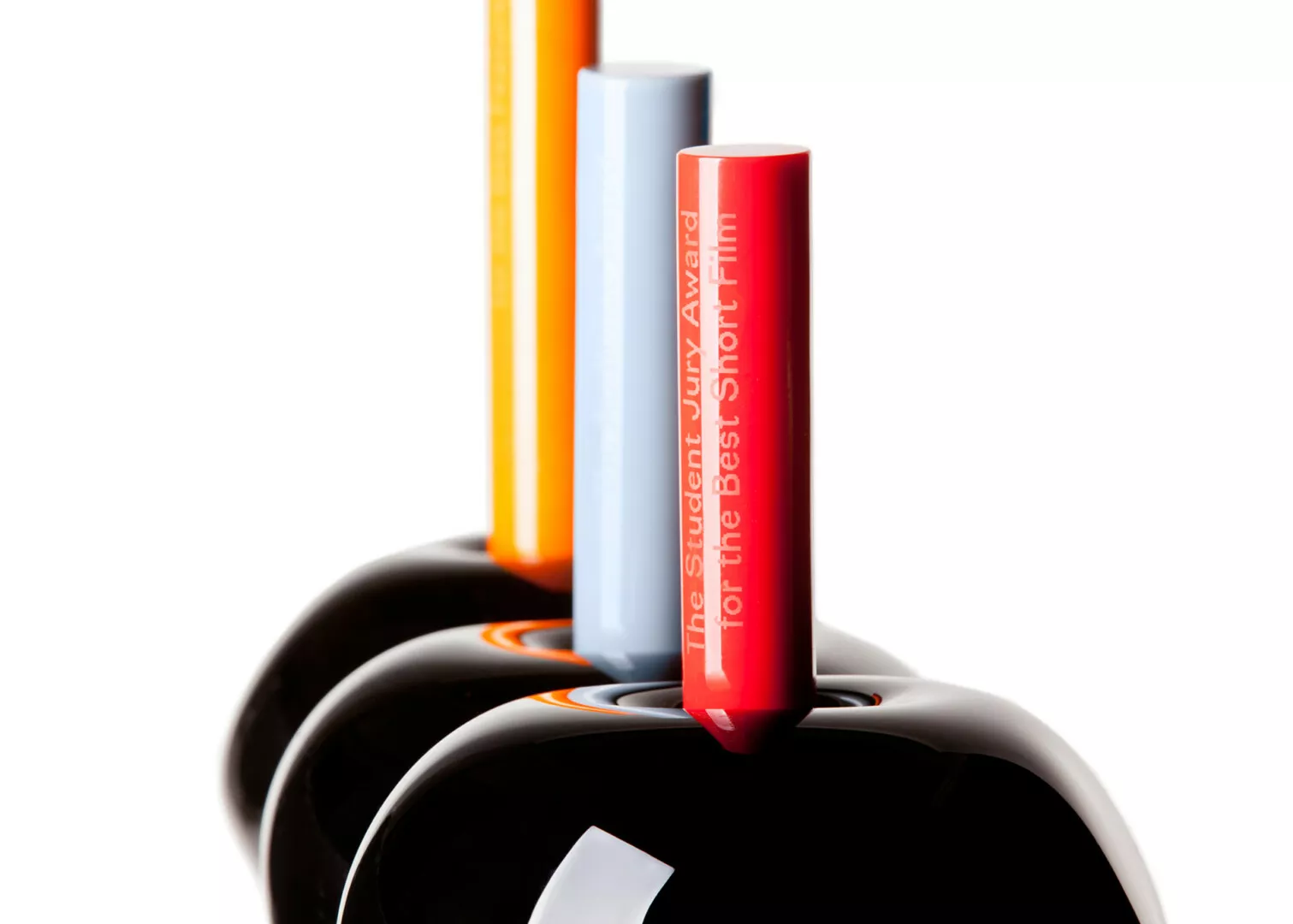 Colorful trophy cylinders for student jury awards.