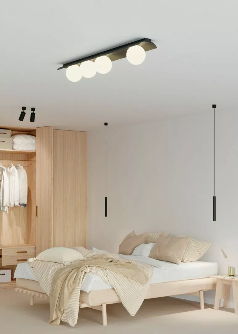 Minimalist bedroom with modern lighting and wooden furniture.
