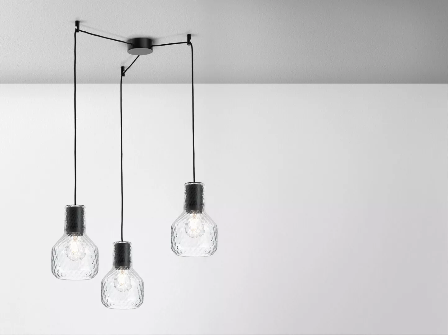 Modern pendant lights hanging on white background.