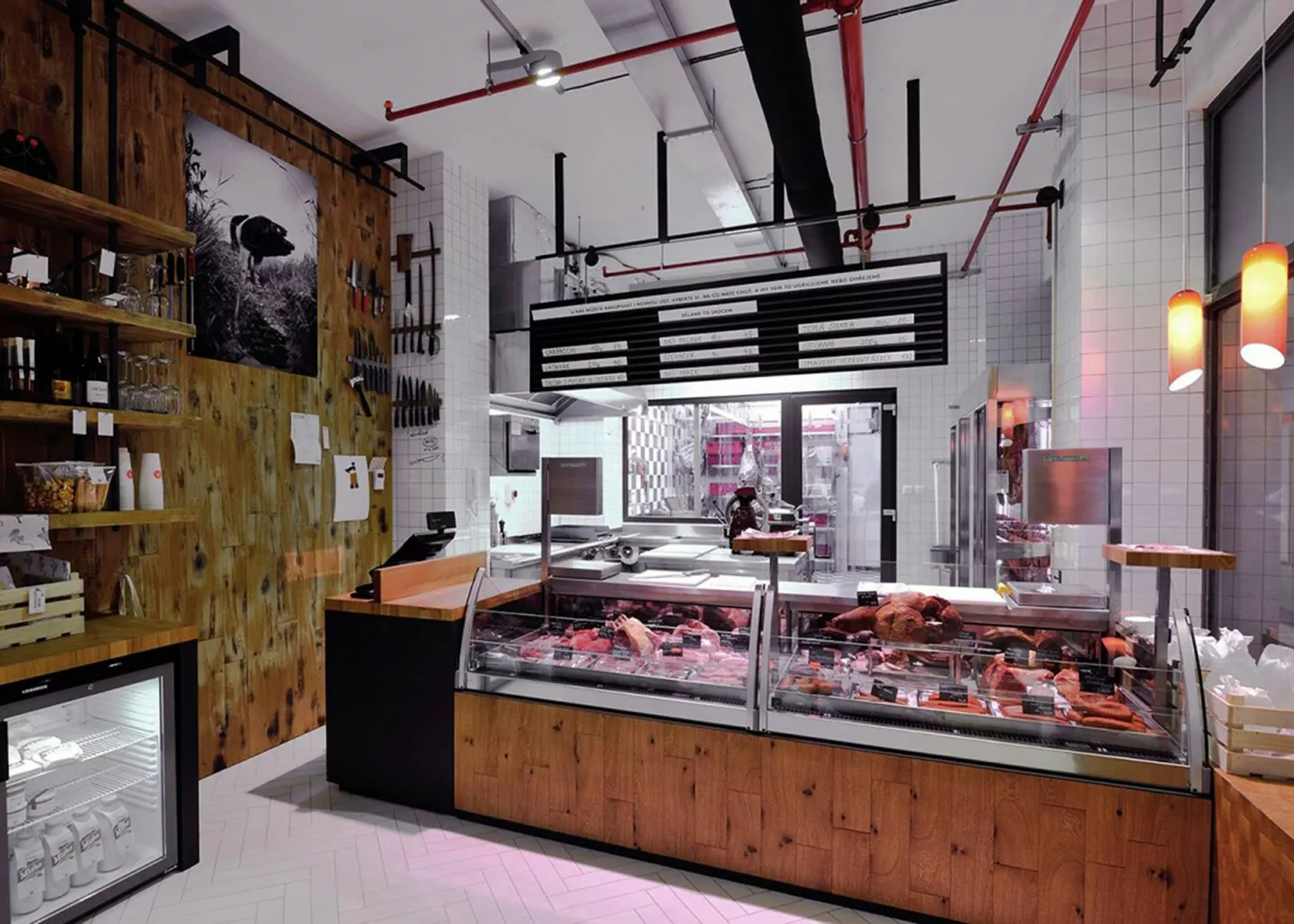 Modern butchery interior with meat display and wooden accents.