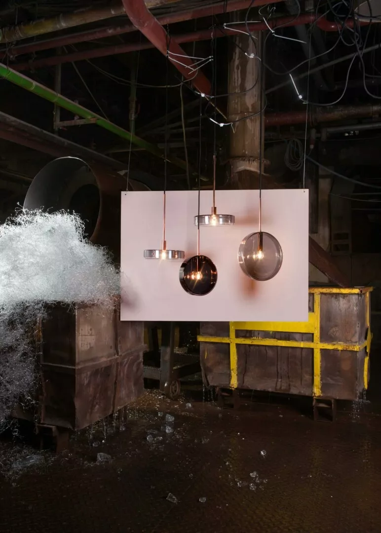 Modern pendant lights displayed in industrial setting.