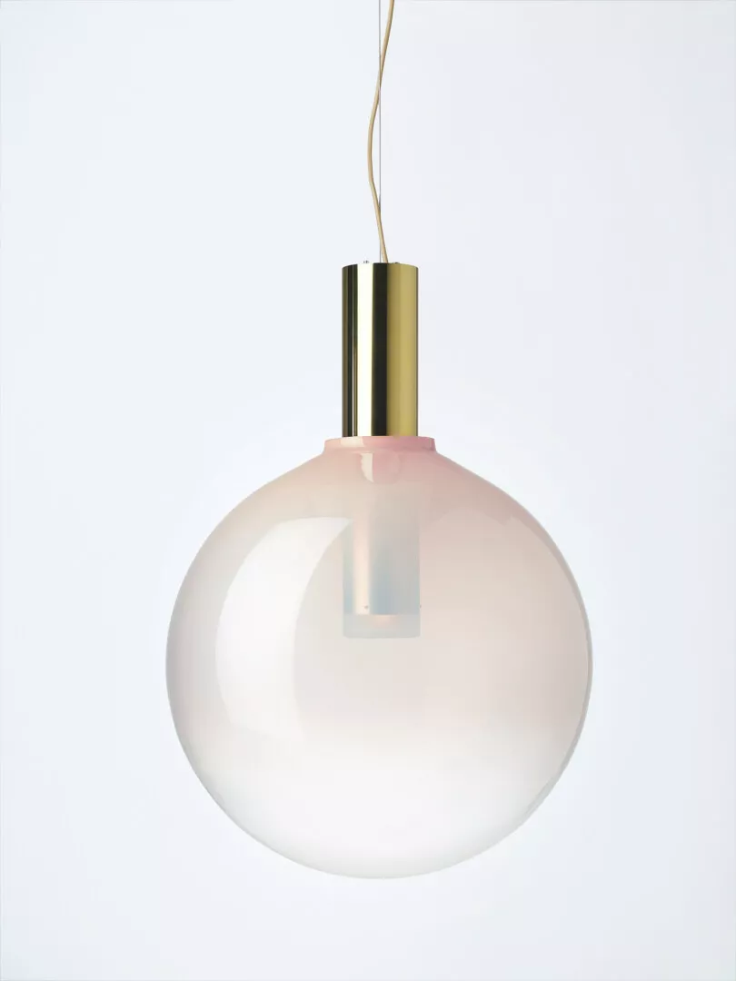 Modern spherical pendant lamp with brass details.