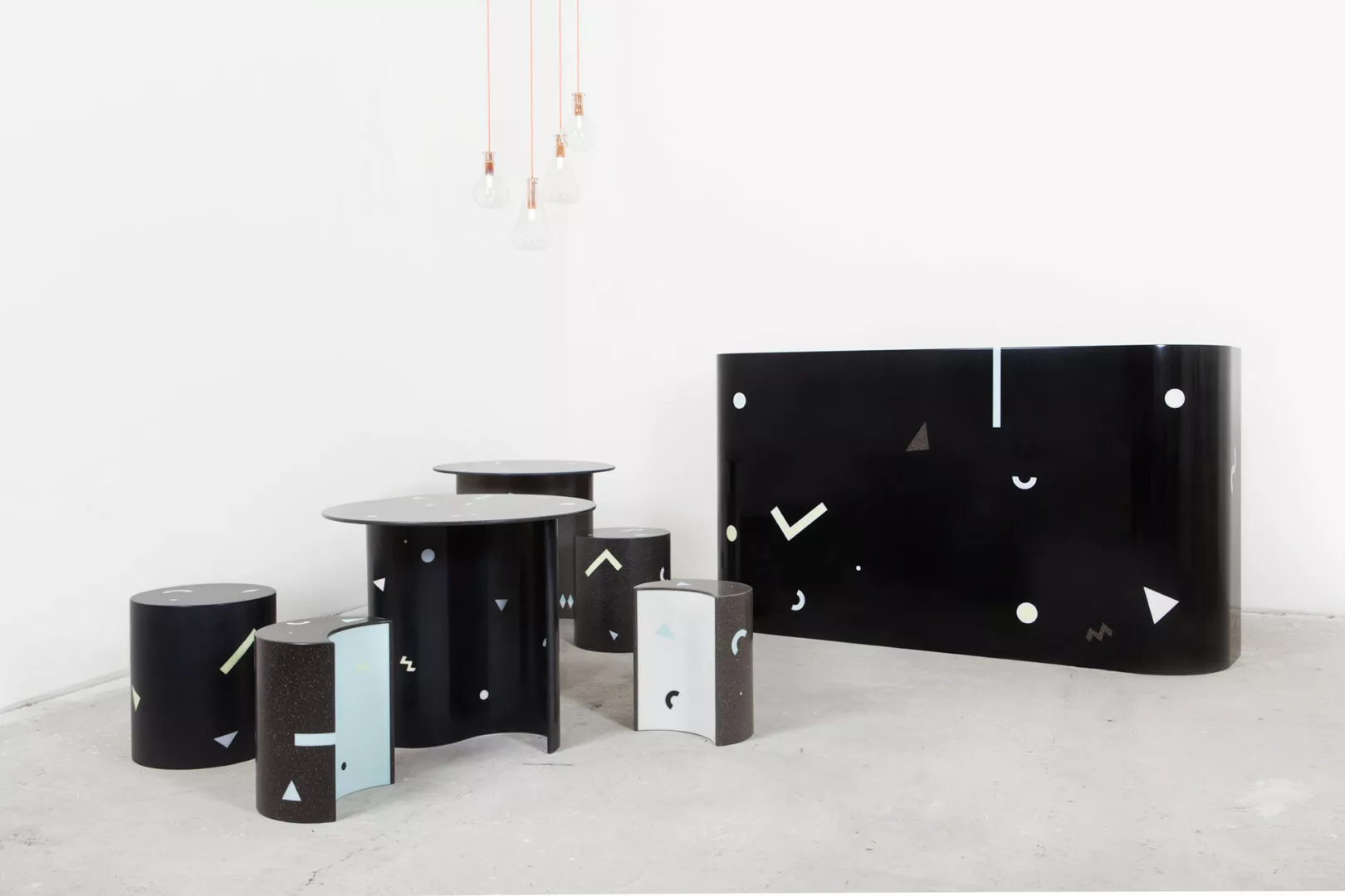 Modern geometric-designed furniture in minimalist setting.