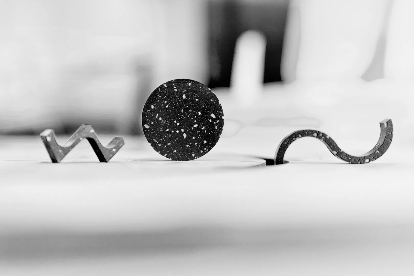 Abstract black and white shapes on surface.