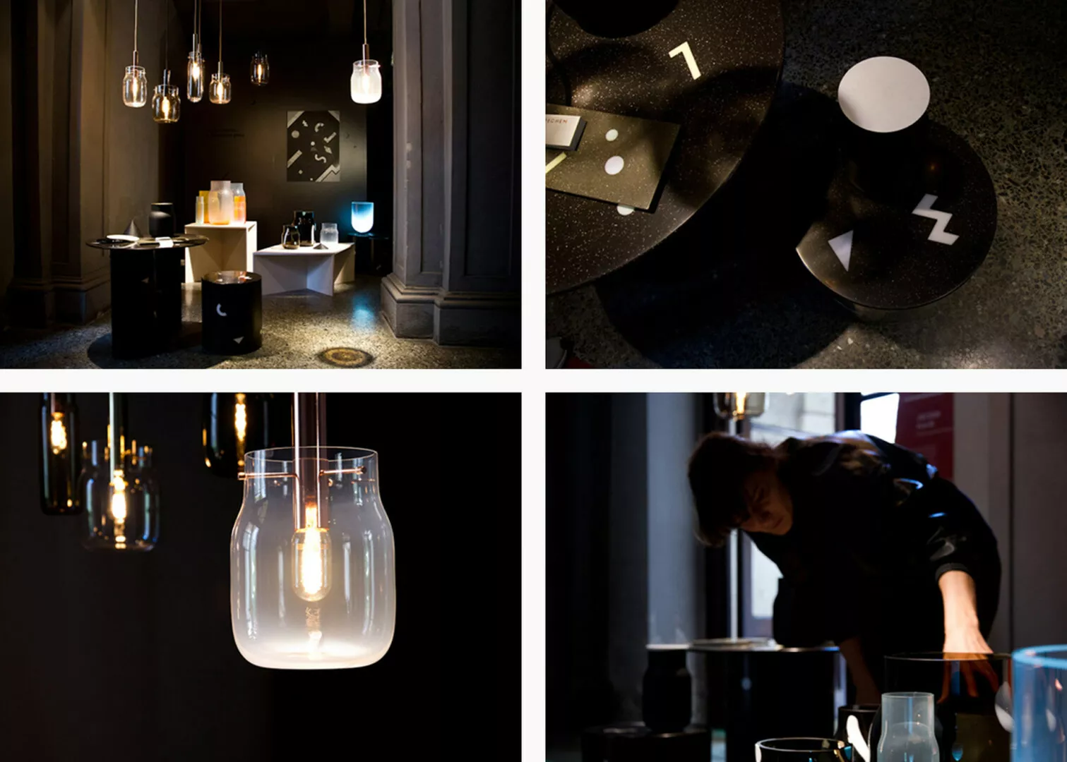 Modern dimly-lit interior with varied hanging light fixtures.