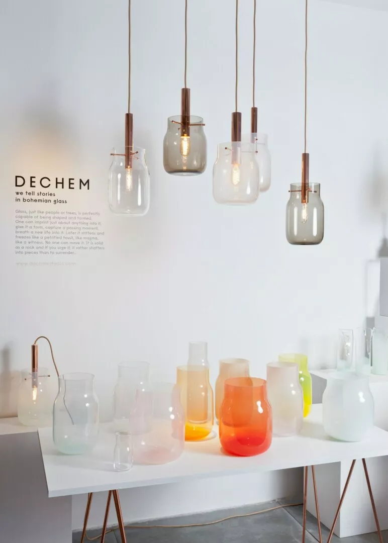 Modern hanging glass pendant lights and glassware on display.
