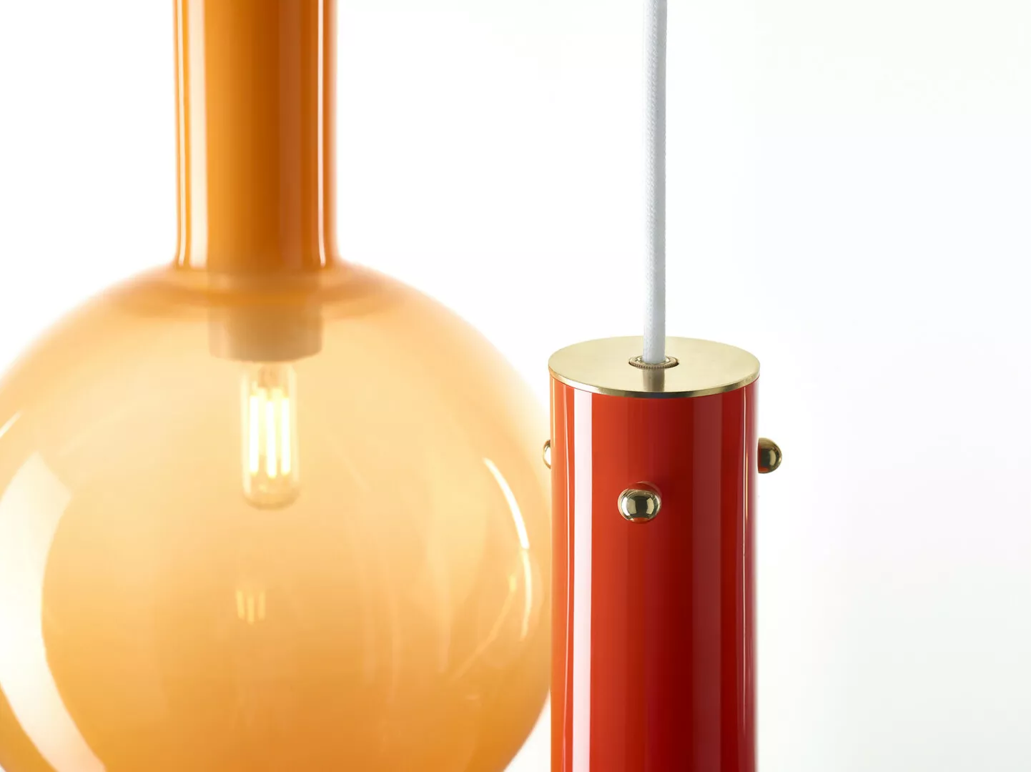 Orange lamp with red cylindrical base.