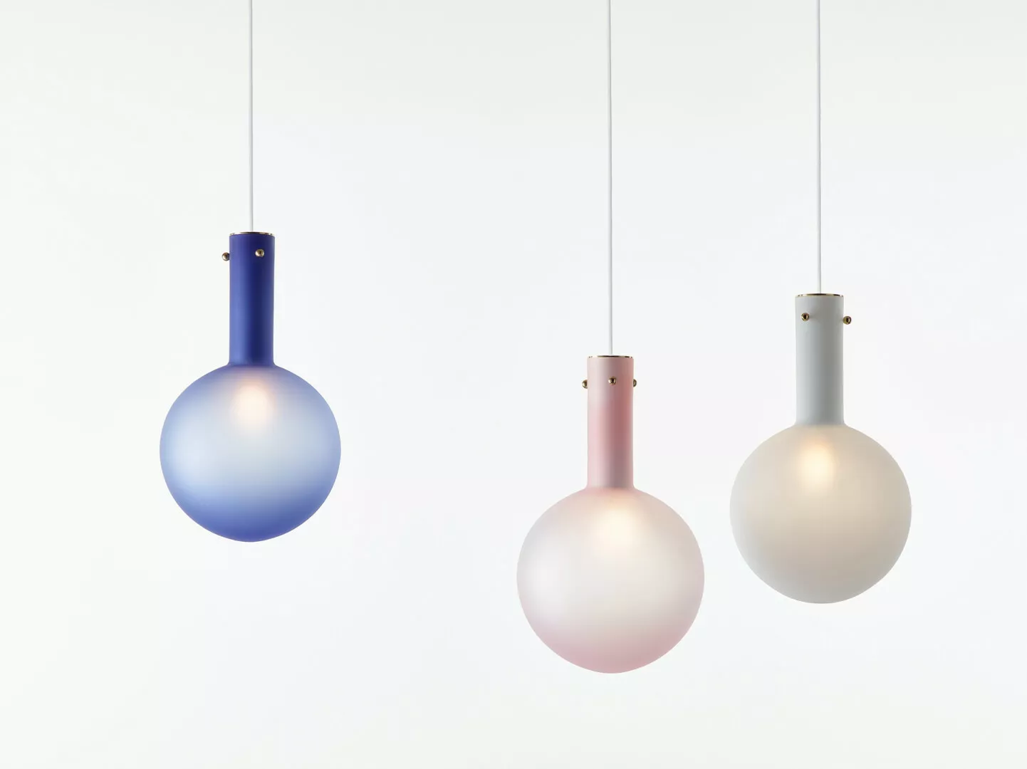 Three colorful pendant lights against white background.