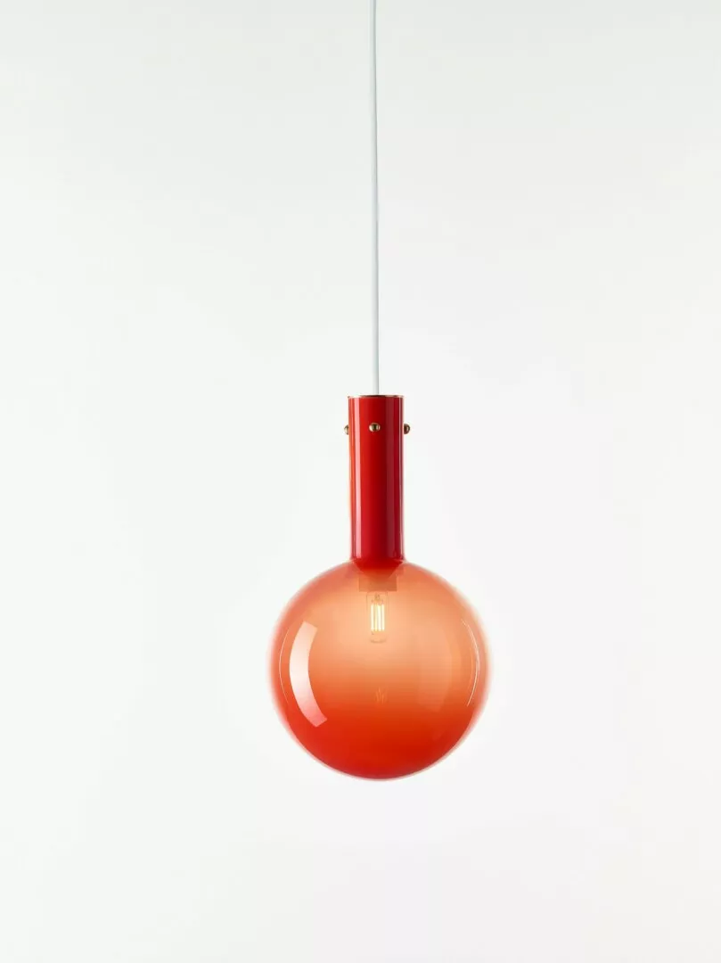 Red pendant light hanging on white background