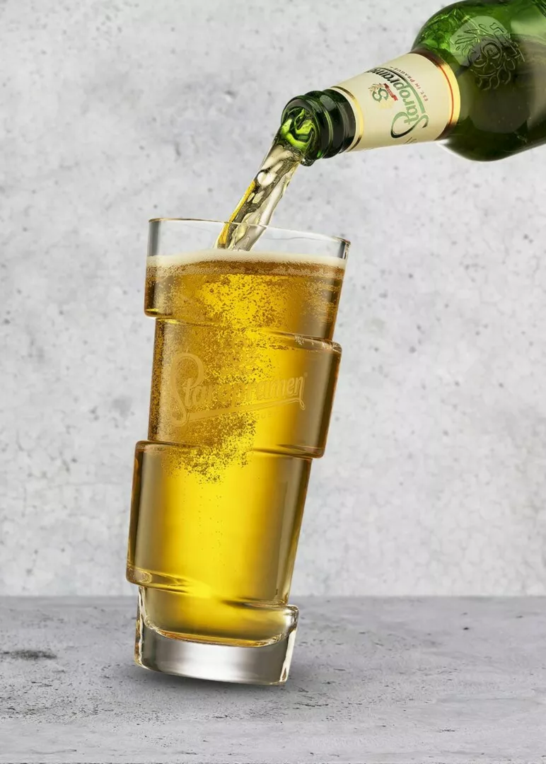 Beer pouring into stacked glasses.