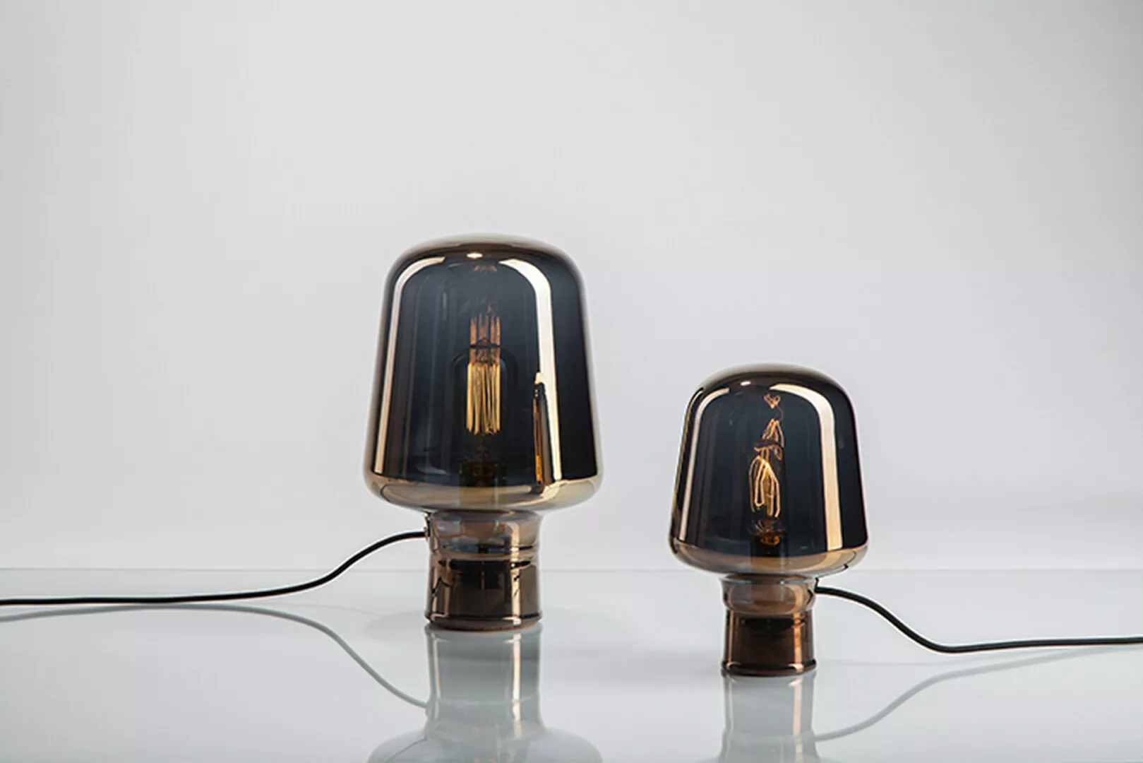 Two modern glass table lamps with visible filaments.