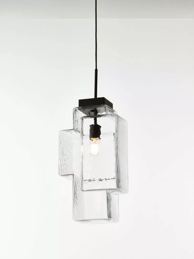 Modern clear glass cube pendant light on white background.