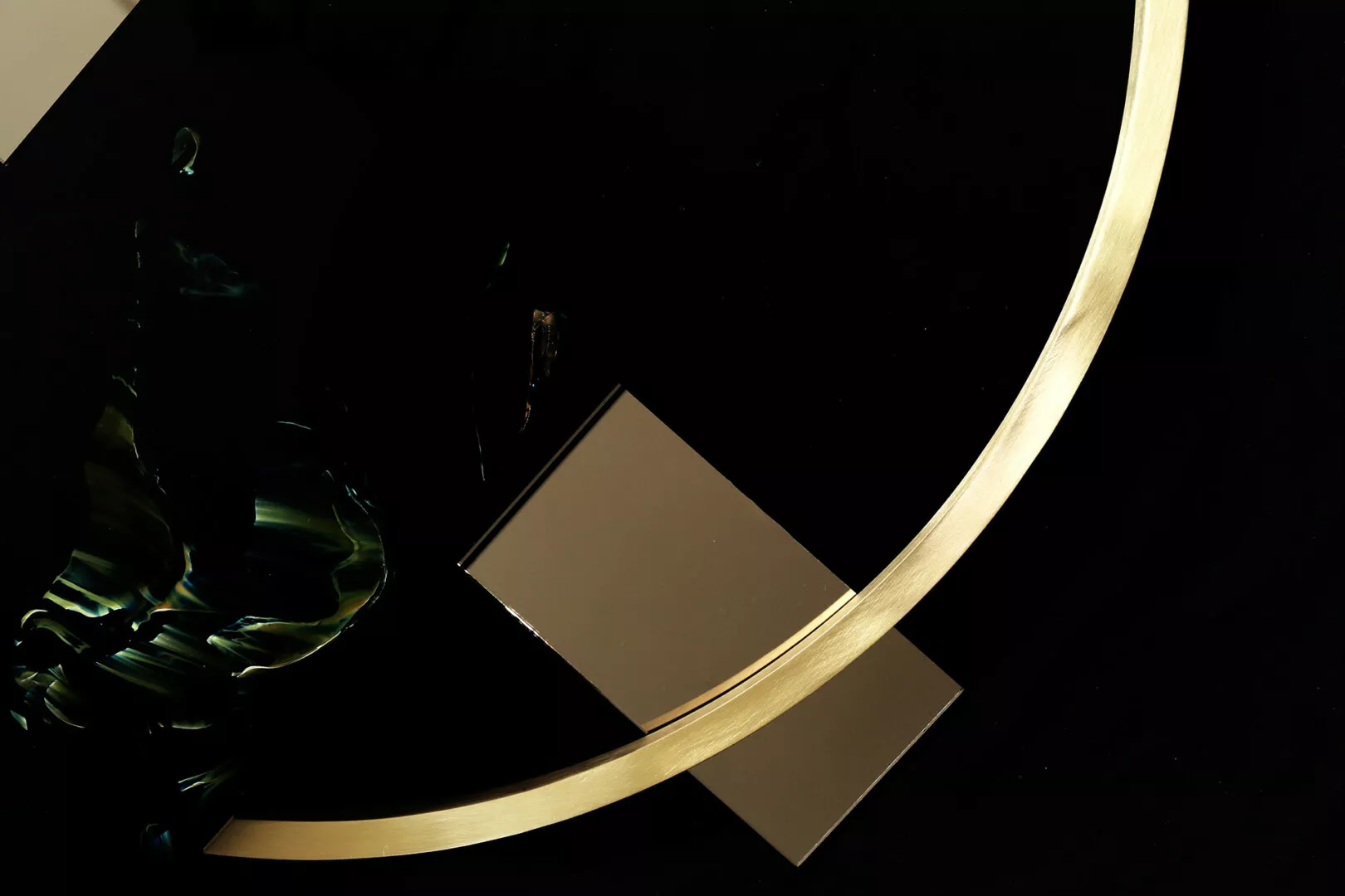 Gold ring and square on black background.