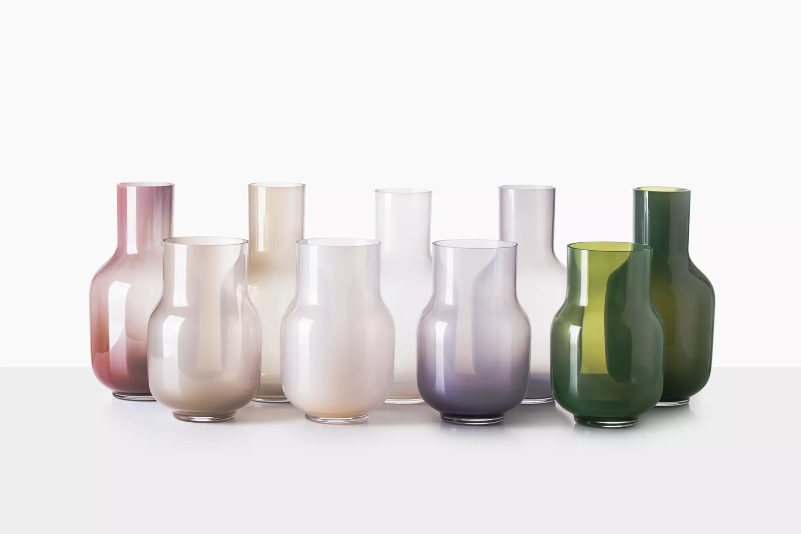 Colorful glass vases collection on white backdrop.